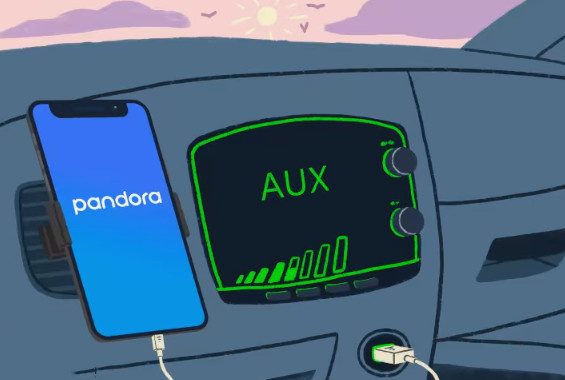 USB経由でカーステレオのAUXジャックに接続されたPandoraを再生するスマートフォン